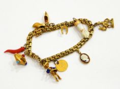 A charm bracelet marked 14ct with assorted charms including an enamelled figure of an accordion