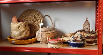 A quantity of African and other baskets, bowls and vessels including some with beadwork decoration,