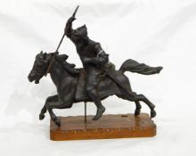 A heavy pewter type metal sculpture of warrior in armour on horseback, on wooden plinth base,