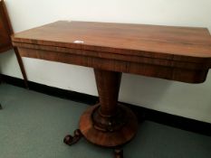 A mahogany rotating top card table with circular base inset, on circular tapering column,