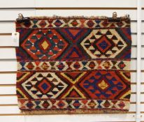 An Anatolian Kelim bedding bag face with two bands of coloured geometric decoration,