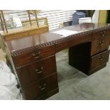 A stained wood chest of drawers with three long drawers below