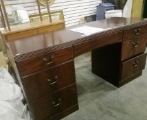 A stained wood chest of drawers with three long drawers below