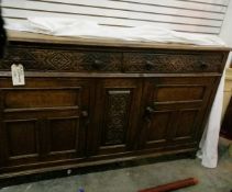 A 19th century oak sideboard with two long frieze drawers, cupboard below, floral scroll carving,