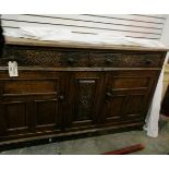 A 19th century oak sideboard with two long frieze drawers, cupboard below, floral scroll carving,
