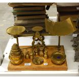 A set of brass parcel scales, limit of weight 11lbs, with brass weights,