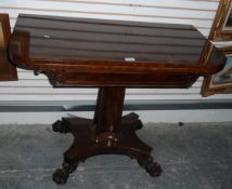 A Victorian mahogany fold-over card table raised on square tapering column with quatrefoil base and