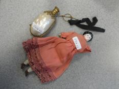 A mother-of-pearl scent bottle and a china doll's house doll