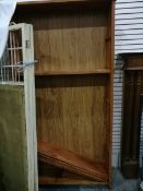 An oak open bookcase with five shelves,