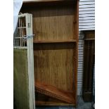 An oak open bookcase with five shelves,