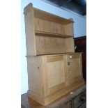 A pine dwarf display cabinet with open shelf, cupboard to base, on block plinth,