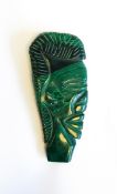 An African carved malachite profile bust of figure's head,