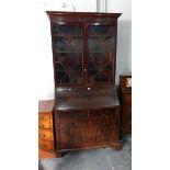 A mahogany bureau bookcase the bureau with leather inset fitted interior,