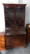 A mahogany bureau bookcase the bureau with leather inset fitted interior,