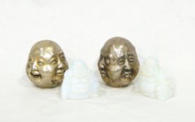 A pair of Oriental opaline glass Buddhas and two white metal quadruple Buddha masks with happy and