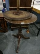 A circular occasional table, turned column supports,