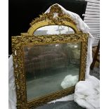 A modern giltwood carved overmantel mirror with floral and scroll decoration together with another