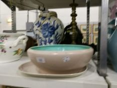 A Poole pottery dish with pink/beige ground and turquoise interior, a matching plate,