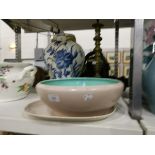 A Poole pottery dish with pink/beige ground and turquoise interior, a matching plate,