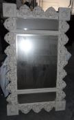A modern white painted mirror with floral decoration,