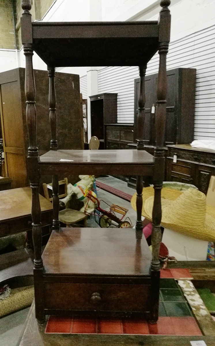 A mahogany three-tier whatnot on turned supports with drawer bottom,