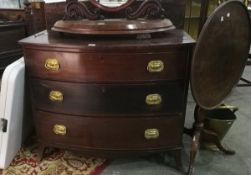 A mahogany bowfronted chest of three graduated drawers, with brass handles, on splayed legs,