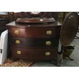 A mahogany bowfronted chest of three graduated drawers, with brass handles, on splayed legs,