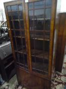 A mahogany glazed bookcase enclosed by pair astragal glazed doors