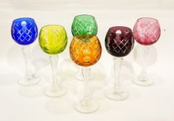 A set of six cut glass harlequin hock glasses,