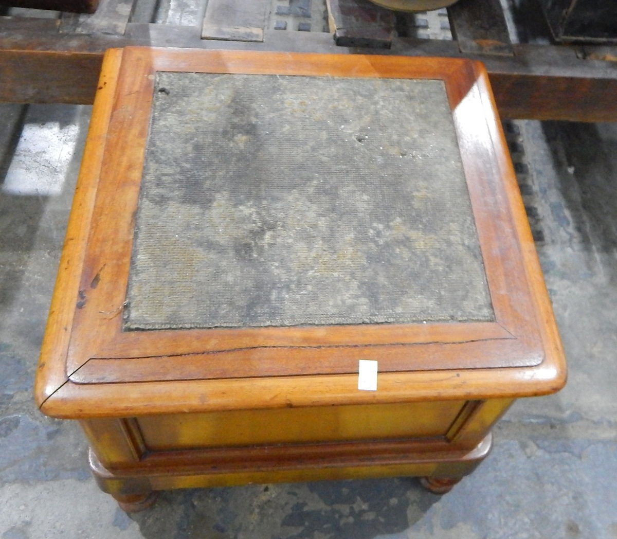 A mahogany commode of square form with hinged upholstered lid,