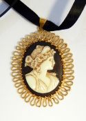 A cameo pendant of female portrait with gold-coloured wrigglework frame and a large silver and Sri