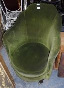 A low green fabric dressing chair on bulbous and castor feet,