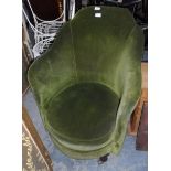 A low green fabric dressing chair on bulbous and castor feet,