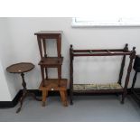 An early 20th century mahogany umbrella stand with turned supports and five compartments with drip