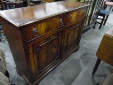 A stained mahogany sideboard with two frieze drawers to top, lion and hoop handles,