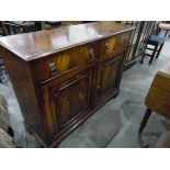 A stained mahogany sideboard with two frieze drawers to top, lion and hoop handles,