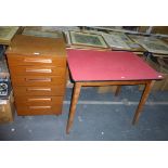 A Schreiber narrow teak chest of six drawers and a 1950's red formica-topped table