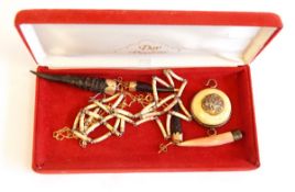 PLEASE NOTE IVORY ITEMS REMOVED A small antelope horn pendant with gold-coloured metal mount and