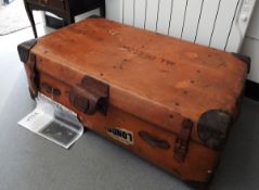 A large leather bound trunk, a smaller leather suitcase,