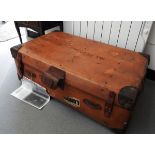 A large leather bound trunk, a smaller leather suitcase,