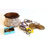Two African brass coils, beadwork jewellery items, tortoiseshell rings,