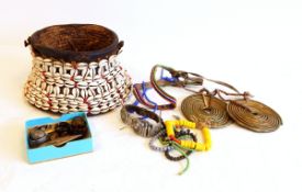 Two African brass coils, beadwork jewellery items, tortoiseshell rings,