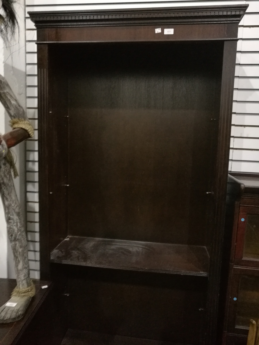 A stained wood open bookcase with four shelves,