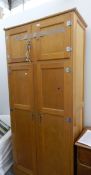 A 20th century Art Deco style oak wardrobe with four cabinets to top,