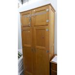 A 20th century Art Deco style oak wardrobe with four cabinets to top,