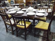 A reproduction mahogany extending dining table
