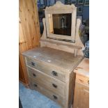 An Edwardian bleached pine dressing chest fitted three drawers with oxidised metal handles,