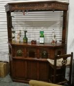 A mahogany style bar complete with two pumps and service optics and two stools,