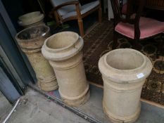 Four chimney pots in various sizes