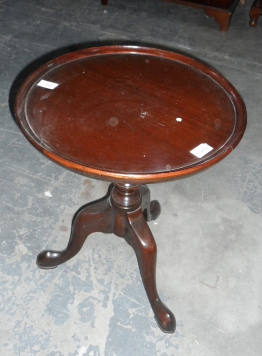 Circular topped occasional table on tripod feet